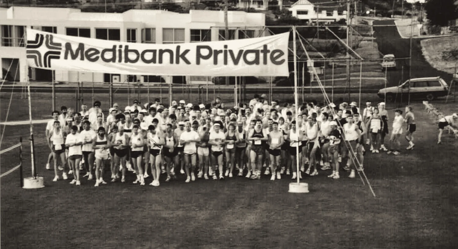 The full field assembled beneath a Medibank Private banner at the start.